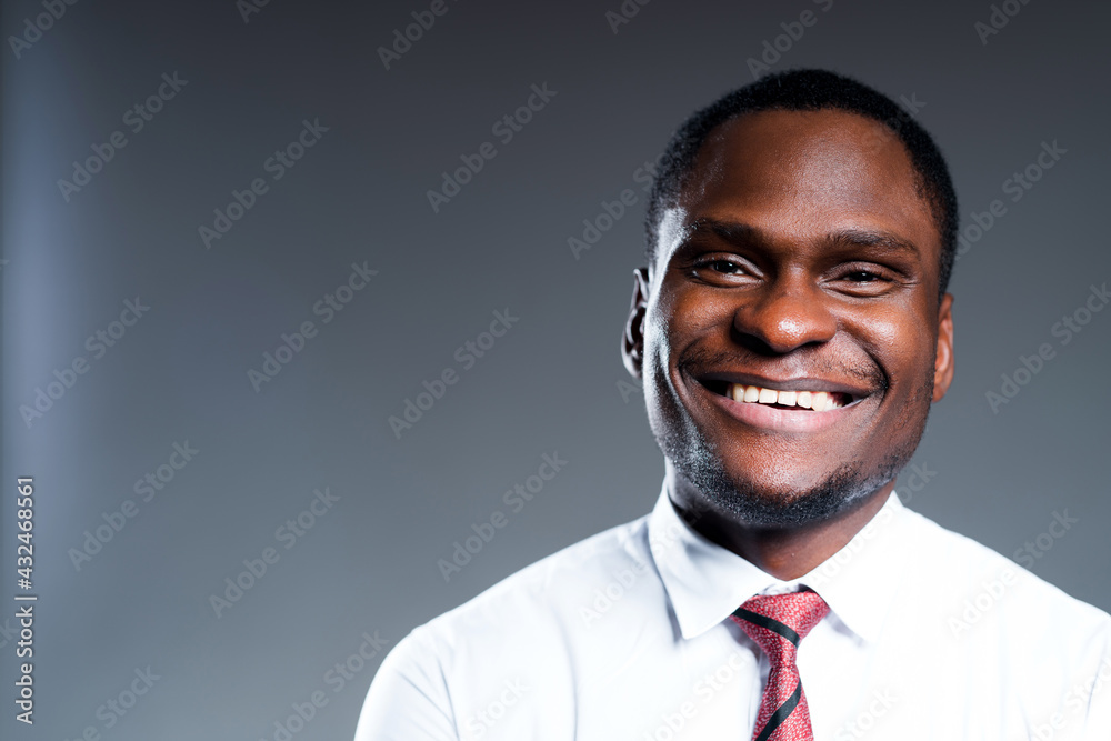 Portrait of happy african american man in white shirt smiling and looking at camera Portrait of happy african american man in white shirt smiling and looking at camera