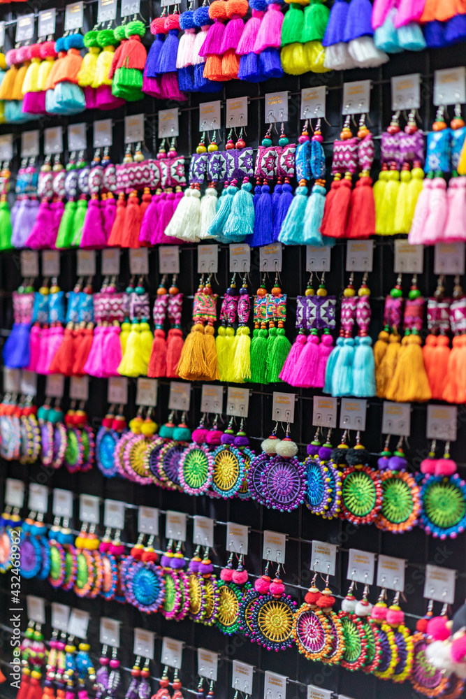 Handmade Souvenir Earring Asian style are hung and display for sales in the shop