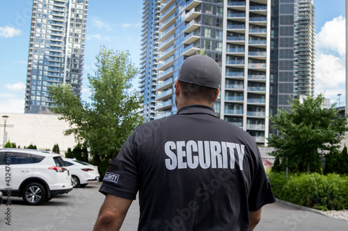 Canvas Print Security guard in uniform patrolling residential area