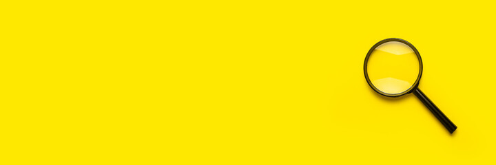 magnifying glass loupe search symbol on yellow background with copy space. Banner