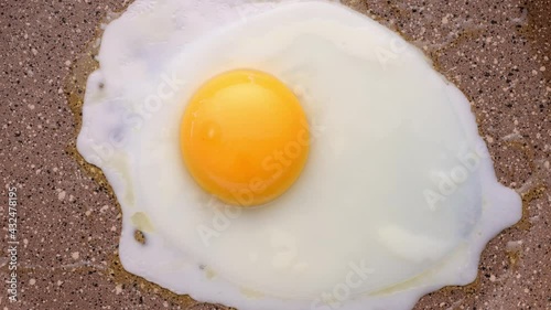 Cooking scrambled eggs in frying pan. Top view, selective focus. Timelapse.