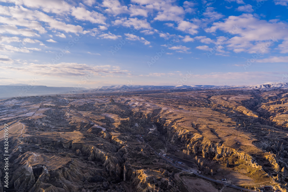 Panorama of the landscapes of Cappadocia, Turkey with fairy chimneys, mountains, rock formations and the town of Ürgüp