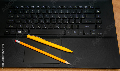 Pen and pencil on the laptop panel.