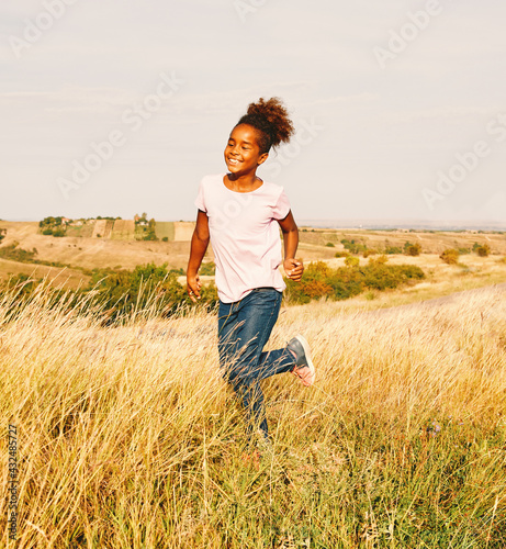 child daughter happy running active healthy carefree fun girl walking cheerful field outdoor nature summer © Lumos sp