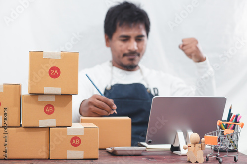 SME entrepreneurs use smartphones to contact customers Work from home to fulfill customer orders through online business websites. Parcel delivery concept 
