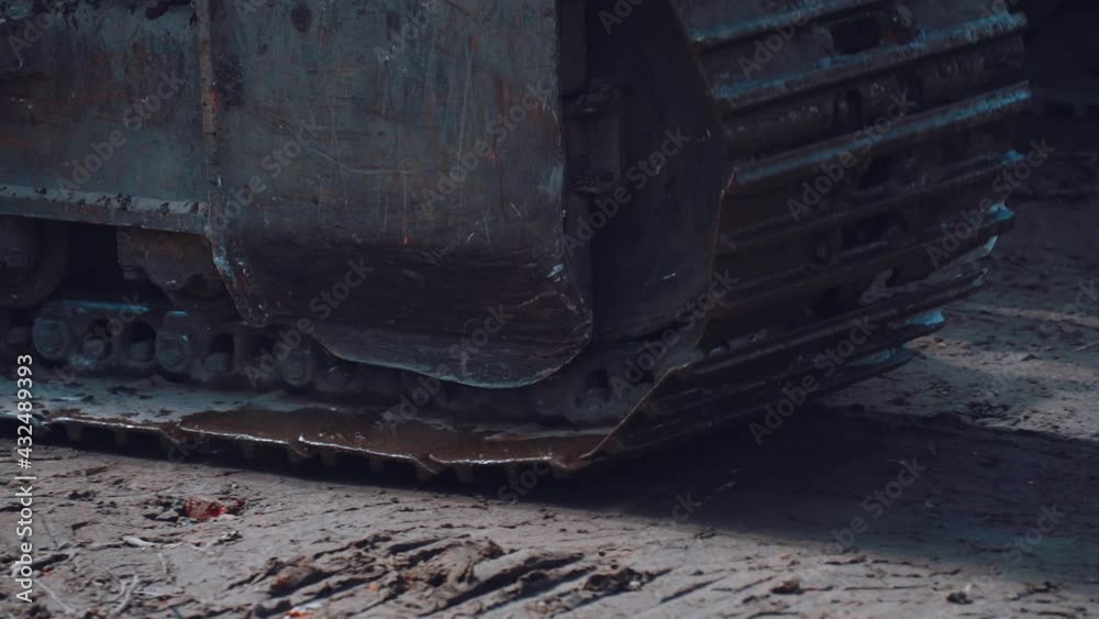 Excavator tracks ride on the ground close-up Excavator tracks ride on the ground close-up