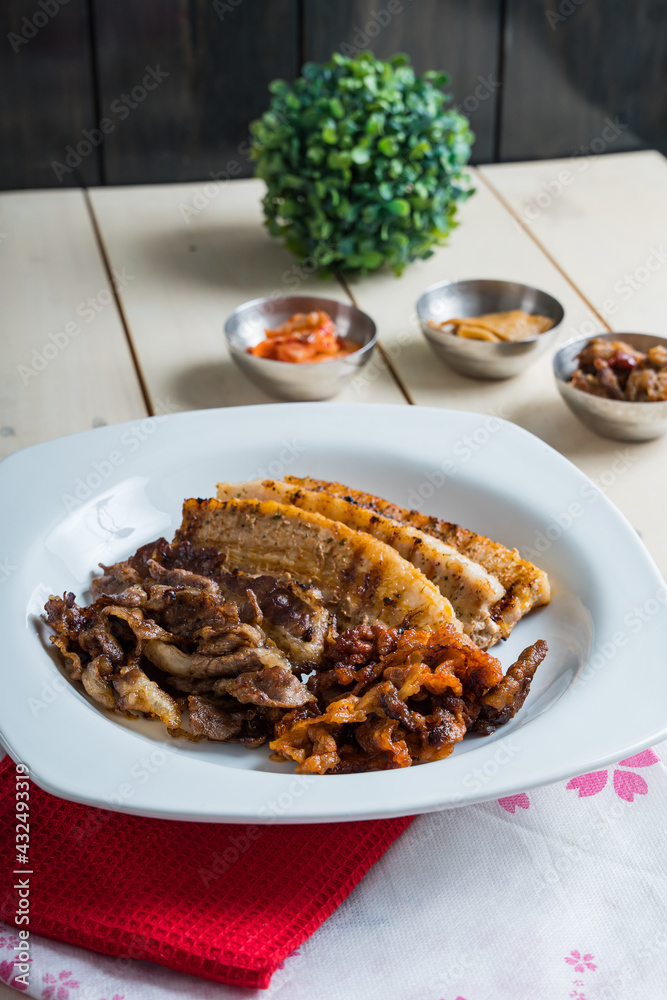 a set of grilled pork belly and marinated thinly sliced beef a set of grilled pork belly and marinated thinly sliced beef