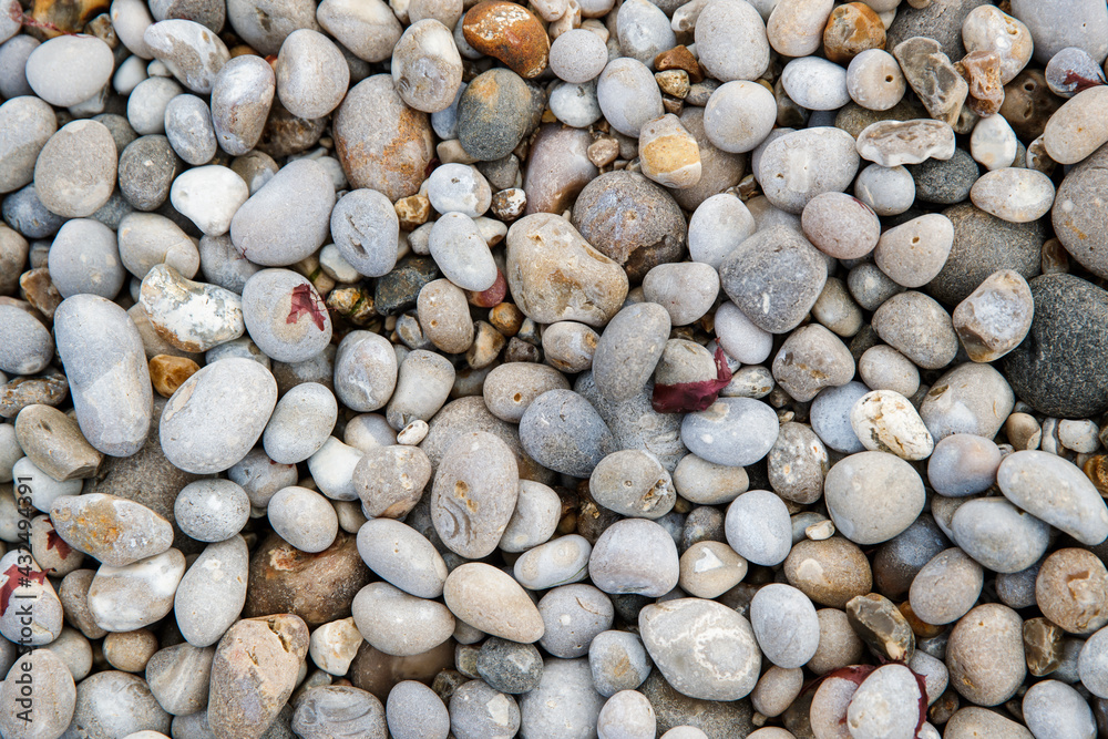 Nature background from beach pebbles, Etretat, France