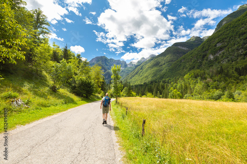 Landscape photo of a woman hiking a trail in the Julian Alps, Triglav National Park, Slovenia.