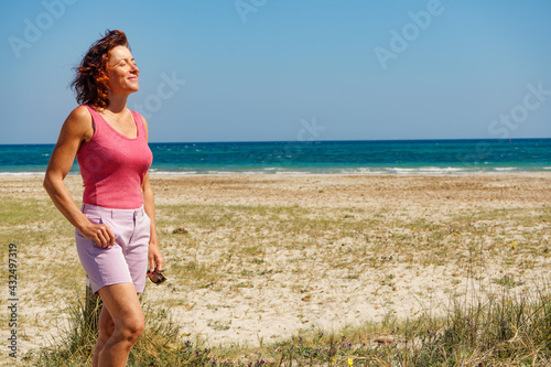 Woman walking on beach, Spain