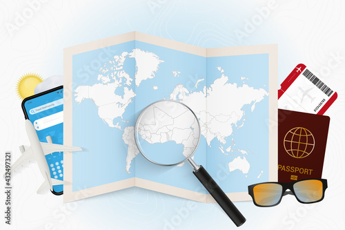 Travel destination Togo, tourism mockup with travel equipment and world map with magnifying glass on a Togo.
