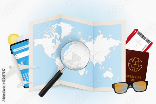 Travel destination Mali, tourism mockup with travel equipment and world map with magnifying glass on a Mali.