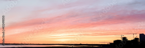 Bright sunset sky and silho...