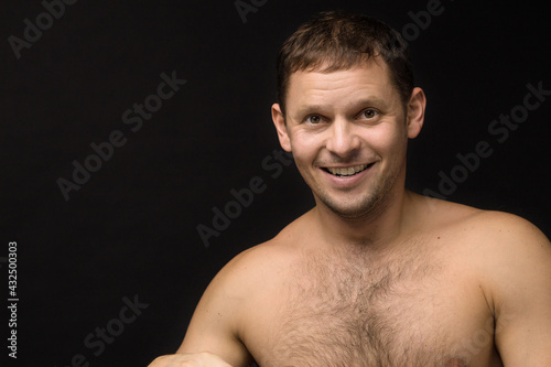 Obraz na płótnie Handsome man on the black background. Muscular and athletic. Man portrait. Male model in studio w salonie
