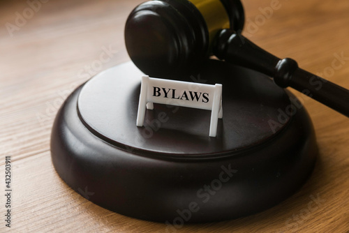 Bylaws phrase with gavel on wooden background. Business and law concept photo