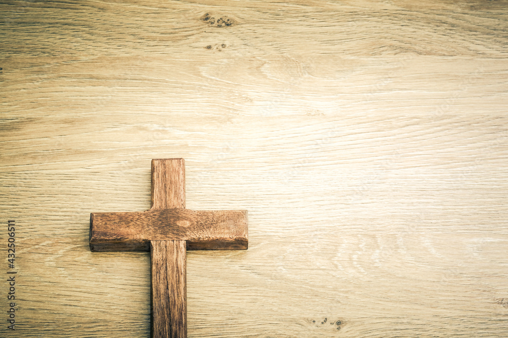 Cross with wooden background concept with large copy space.