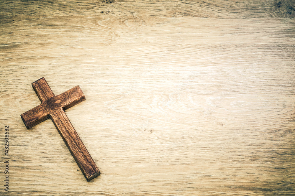 Cross with wooden background concept with large copy space.