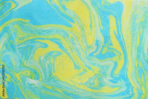Abstract art by blue and yellow watercolor on a paper