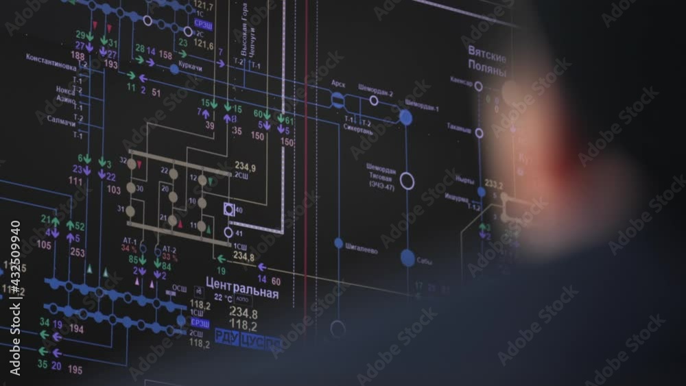 Operator controls equipment looking at black screen with circuit schemes in control room of production plant extreme closeup