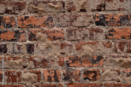 Very old brick wall close up showing decay and weathering