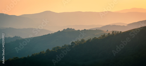 The ridgeline of Carpathian mountains in dusk sunlight. Wide-angle landscape.