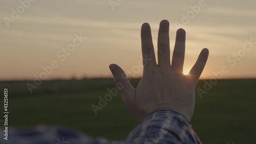 Happy man s hand at sunset. Sunset between the hands of a man. Happy man with dreamily stretches out his hand to the sun. Dream hand to the sun. happy family concept
