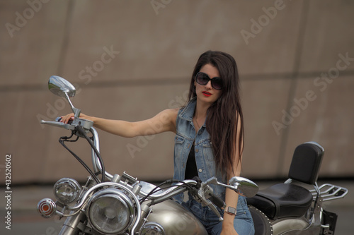 Portrait of young woman on a motorcycle