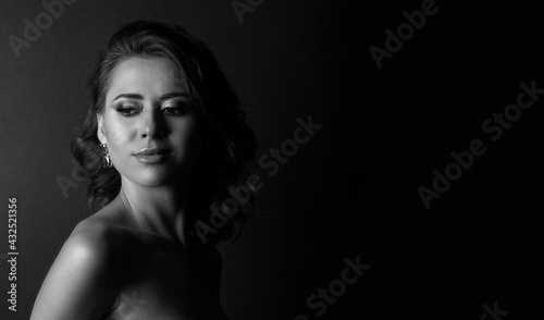 Monochrome portrait of an attractive young woman at studio