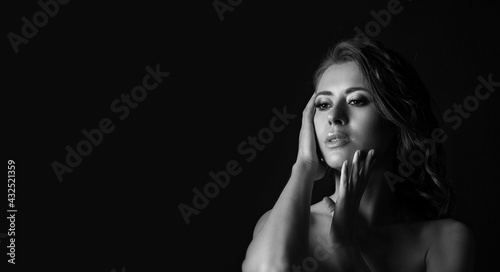 Monochrome portrait of a gorgeous young woman at studio