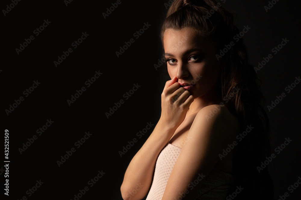 Closeup studio portrait of a romantic woman posing in the dark Closeup studio portrait of a romantic woman posing in the dark