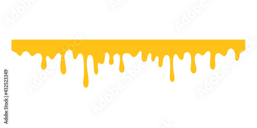 Honey is dripping. The thick yellow liquid dripping onto the ground.