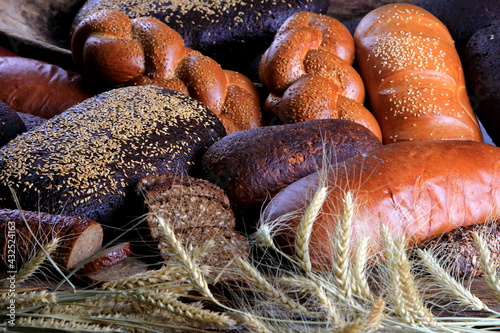 Still life with different types of bread: black, rye, white bread, bread with seeds. bread and wheat ears. 