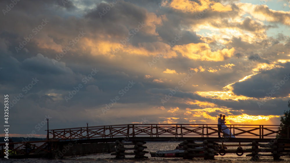 Wedding, silhouette of the couple against the background of the sunset