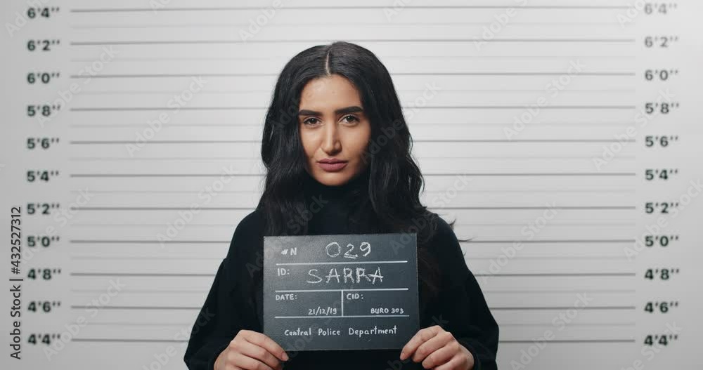 Video „Mugshot of mixed race woman with black wavy hair holding sign ...