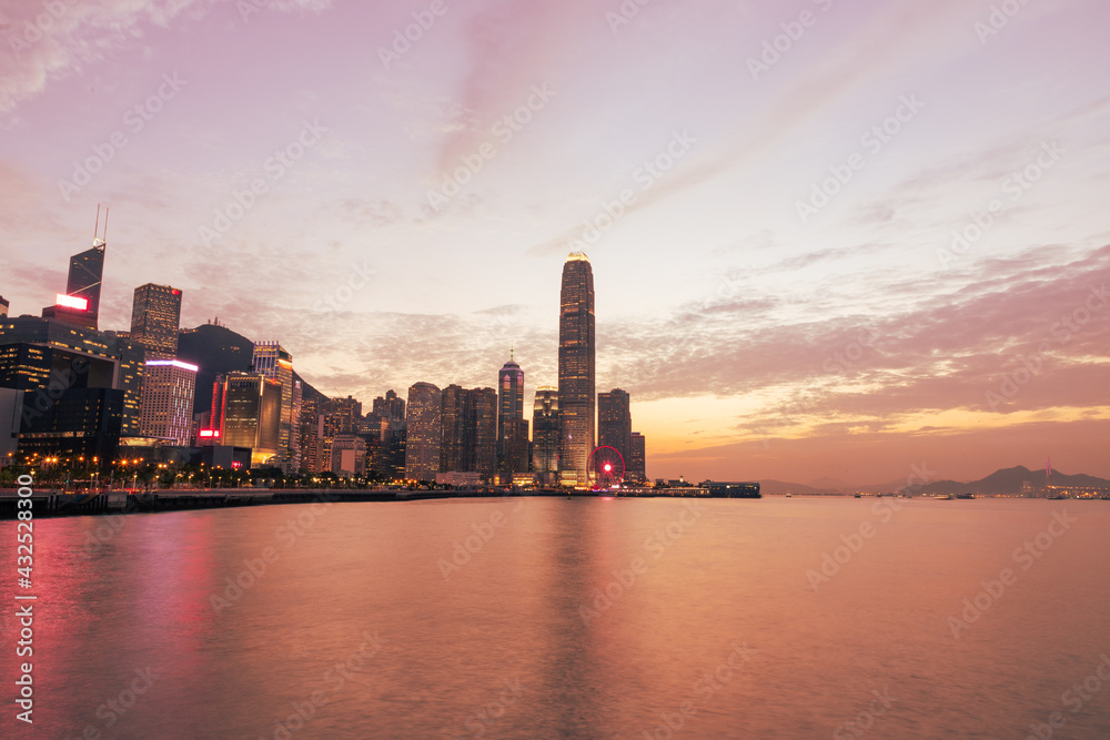 skyline panorama of  Colourful magnificent sunset city view of Central and admiralty, Victoria Harbour, Hong Kong, photo from Wan Chai promenade