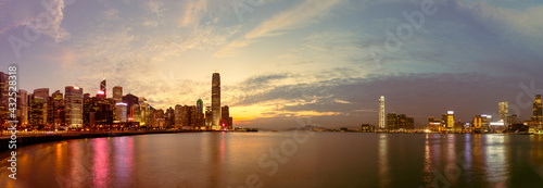 skyline panorama of Colorful magnificent sunset city view of Central and kowloon on both sides of Victoria Harbour, Hong Kong, photo from Wan Chai promenade