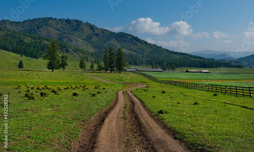 Russia. South Of Western Siberia, Mountain Altai. Summer dirt road along pastures in the Yabogan River valley.