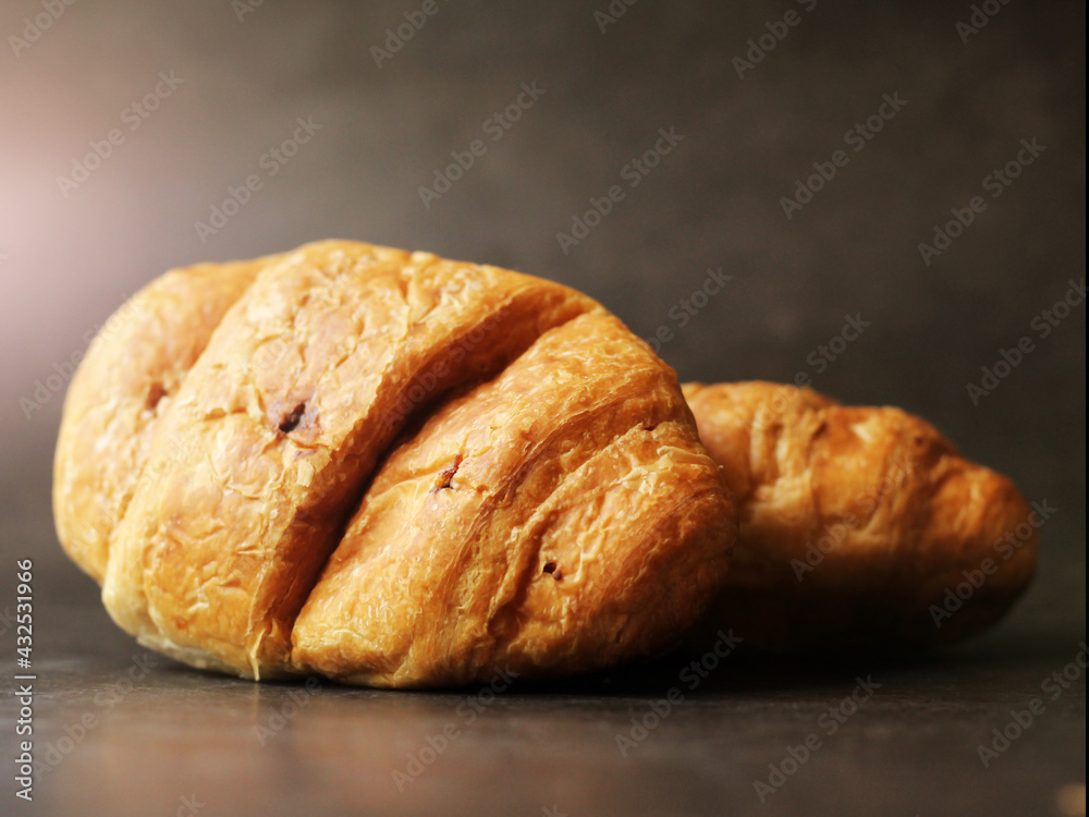 Delicious fresh croissants on a black background