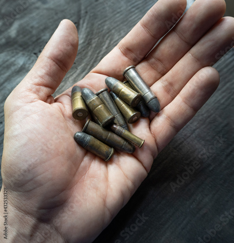 Old bullets on man's hand
