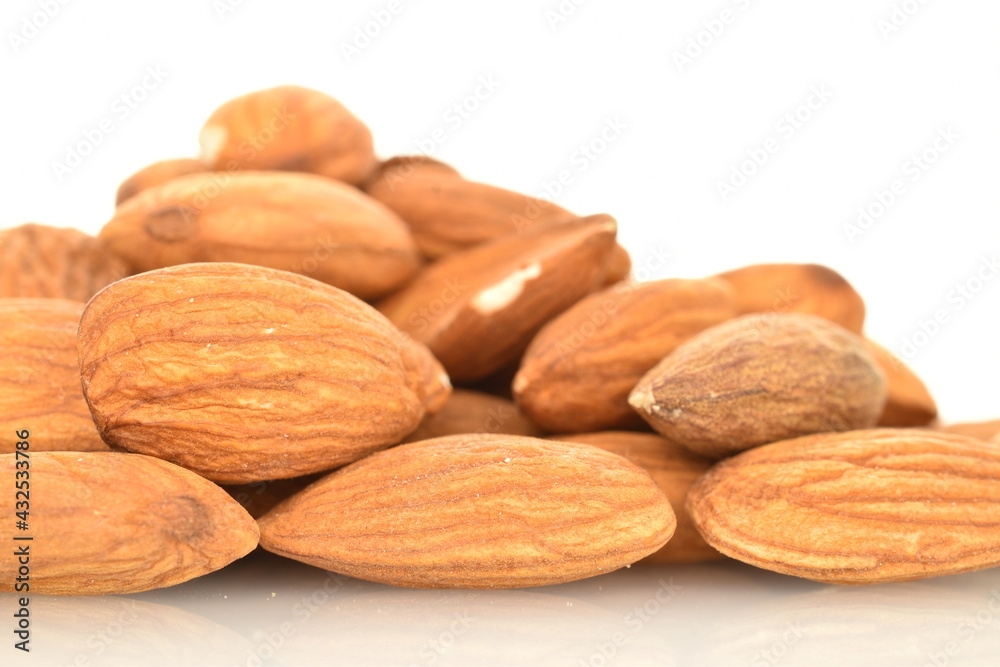 Several grains of peeled raw, organic almonds, close-up, isolated on white. Several grains of peeled raw, organic almonds, close-up, isolated on white.
