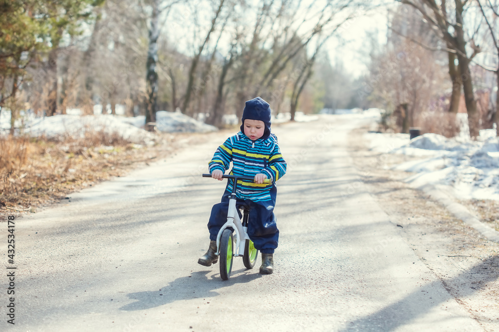 A little Caucasian boy 2 years old learns to ride a balance bike A little Caucasian boy 2 years old learns to ride a balance bike