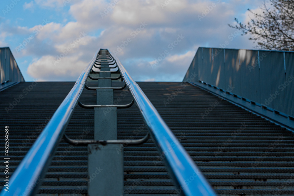 Partial view of an outdoor stairs from a pedestrian bridge in Maastricht, creating an conceptual view of a daily life construction work. Partial view of an outdoor stairs from a pedestrian bridge in Maastricht, creating an conceptual view of a daily life construction work.