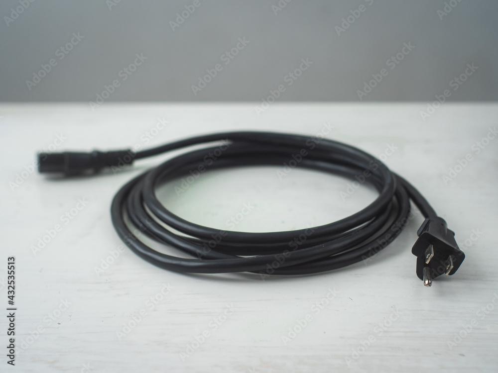 Black Cables against a White and Gray Surface Black Cables against a White and Gray Surface