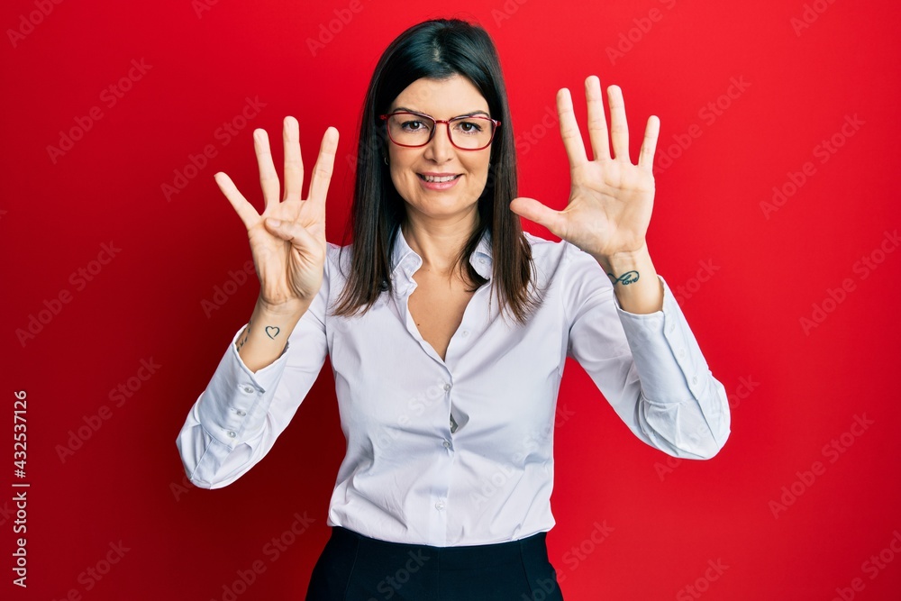 Young hispanic woman wearing business shirt and glasses showing and pointing up with fingers number nine while smiling confident and happy. Young hispanic woman wearing business shirt and glasses showing and pointing up with fingers number nine while smiling confident and happy.