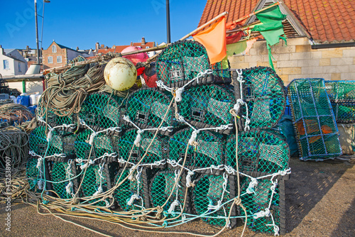 Lobster pots stacked up on a harbor quayside