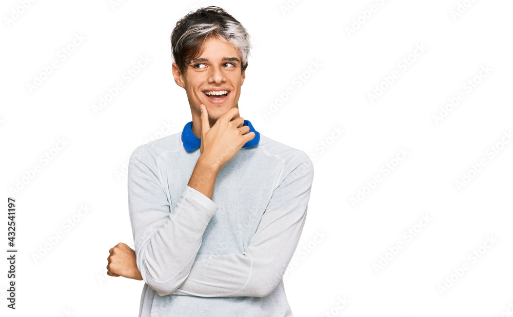 Young hispanic man wearing casual clothes with hand on chin thinking about question, pensive expression. smiling with thoughtful face. doubt concept. Young hispanic man wearing casual clothes with hand on chin thinking about question, pensive expression. smiling with thoughtful face. doubt concept.