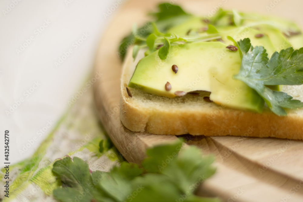 Sandwich with avocado slices and parsley Sandwich with avocado slices and parsley