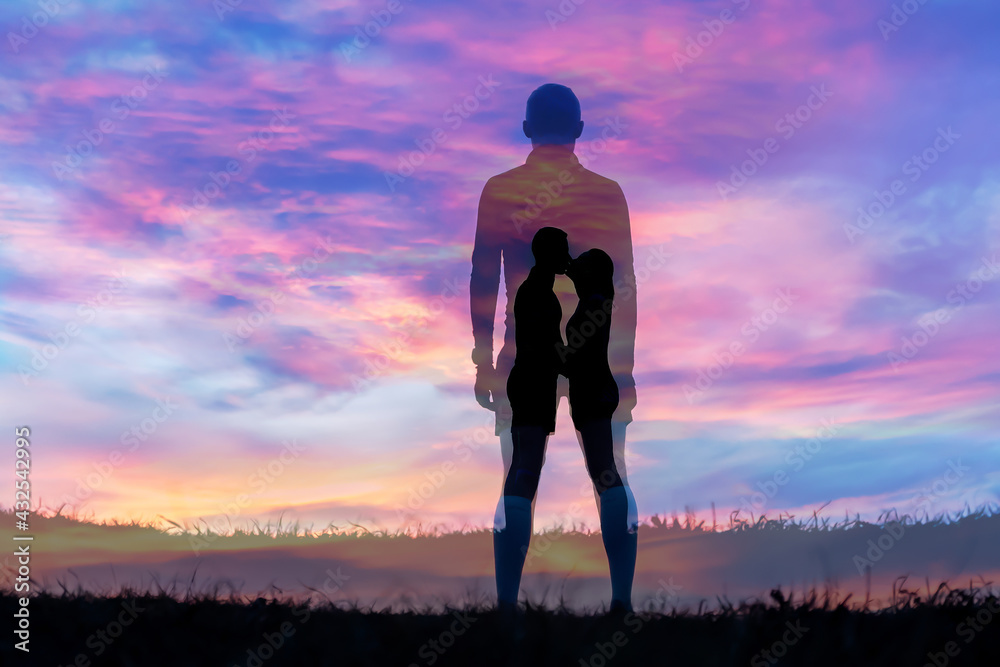 Silhouette man on grass with sunset background