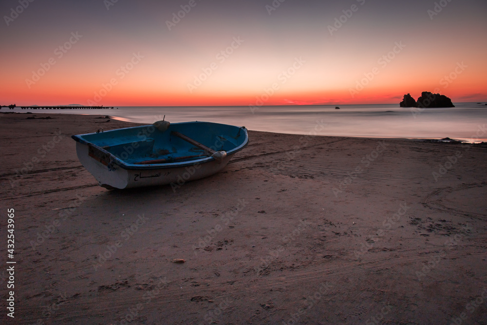 boat at sunset on the beach