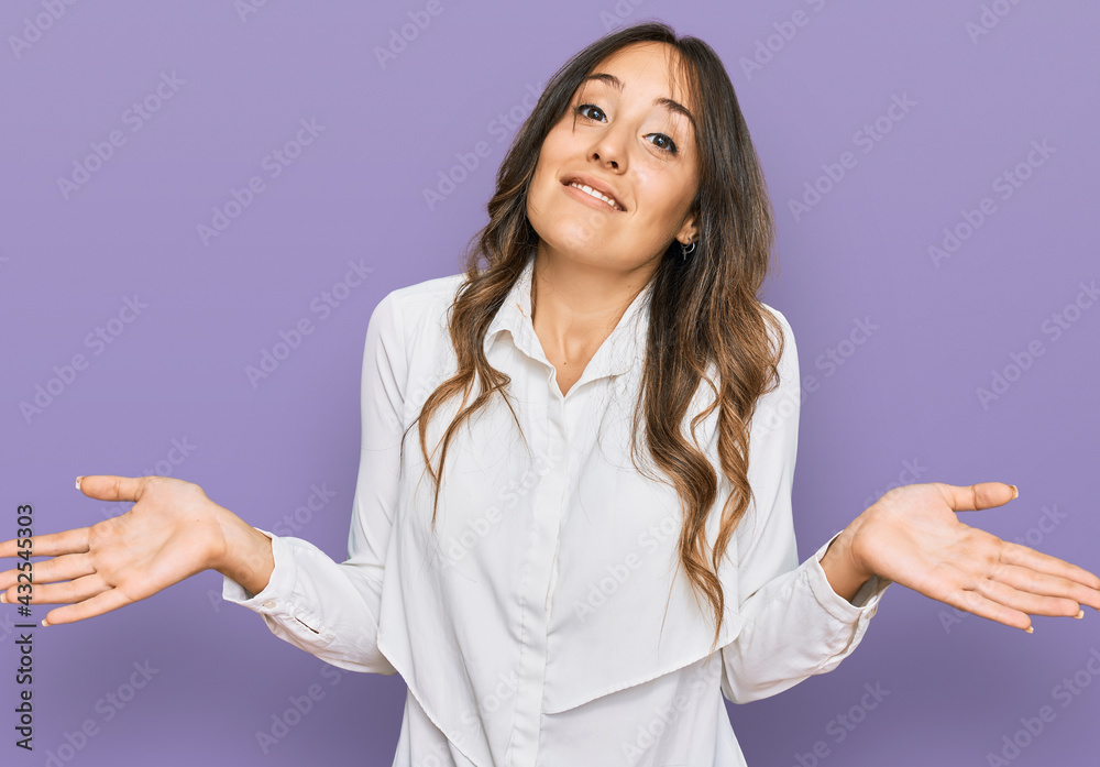 Young brunette woman wearing casual clothes clueless and confused expression with arms and hands raised. doubt concept. Young brunette woman wearing casual clothes clueless and confused expression with arms and hands raised. doubt concept.